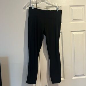 Lululemon size 12 black leggings with mesh on lower sides starting at knee.